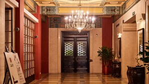 A grand lobby with a checkered floor, a large chandelier, and a black ornate door. - Jinjiang Metropolo Hotel Classiq, YMCA (Shanghai)