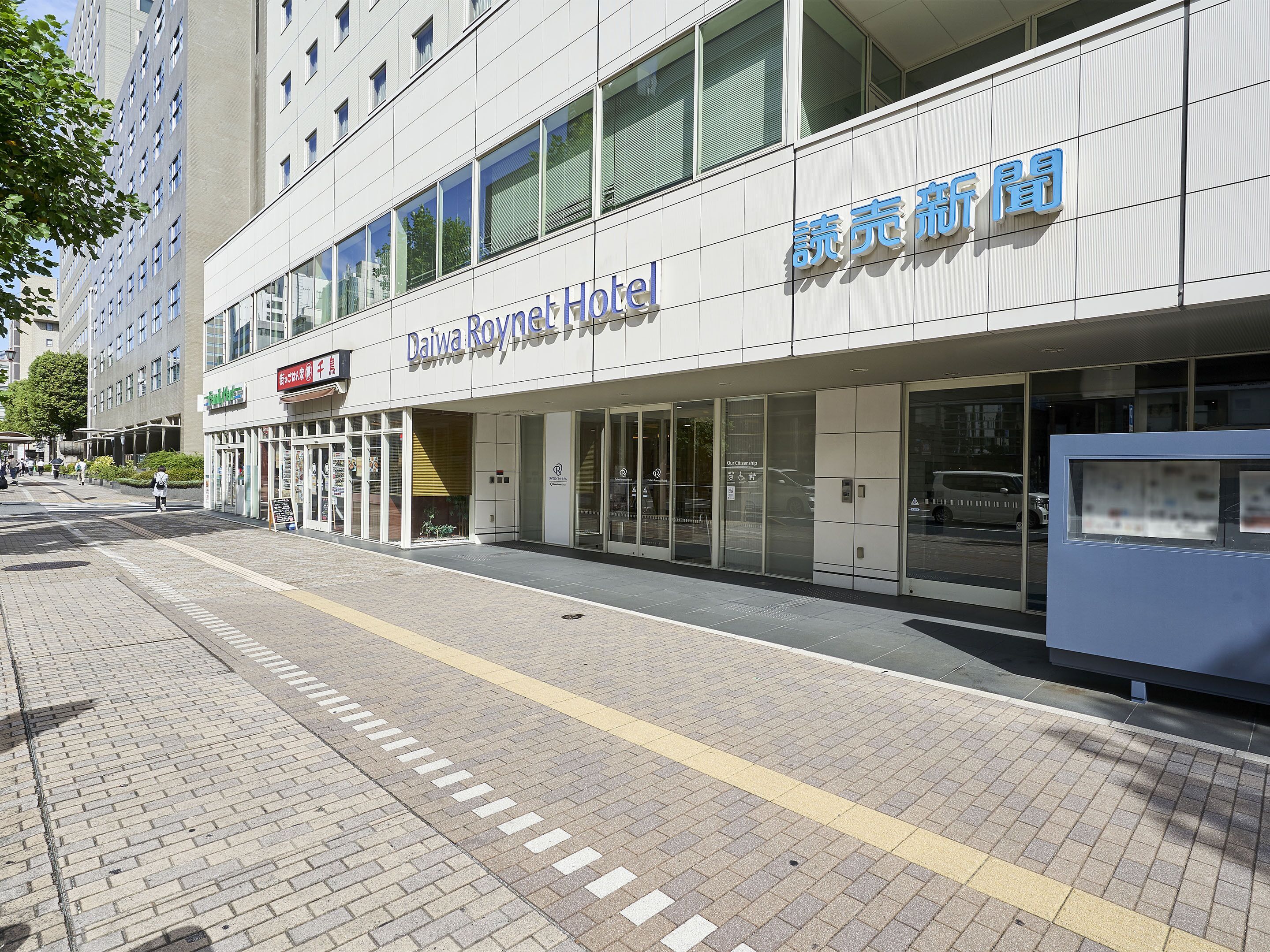 The exterior of the Daiwa Roynet Hotel with a modern facade, large windows, and a clear entrance.