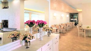 A hotel lobby with a reception desk, seating area, and a large mirror. - Hotel Grenada - All Inclusive (Sunny Beach)