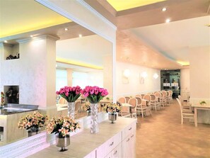 A hotel lobby with a reception desk, seating area, and a large mirror. - Hotel Grenada - All Inclusive (Sunny Beach)