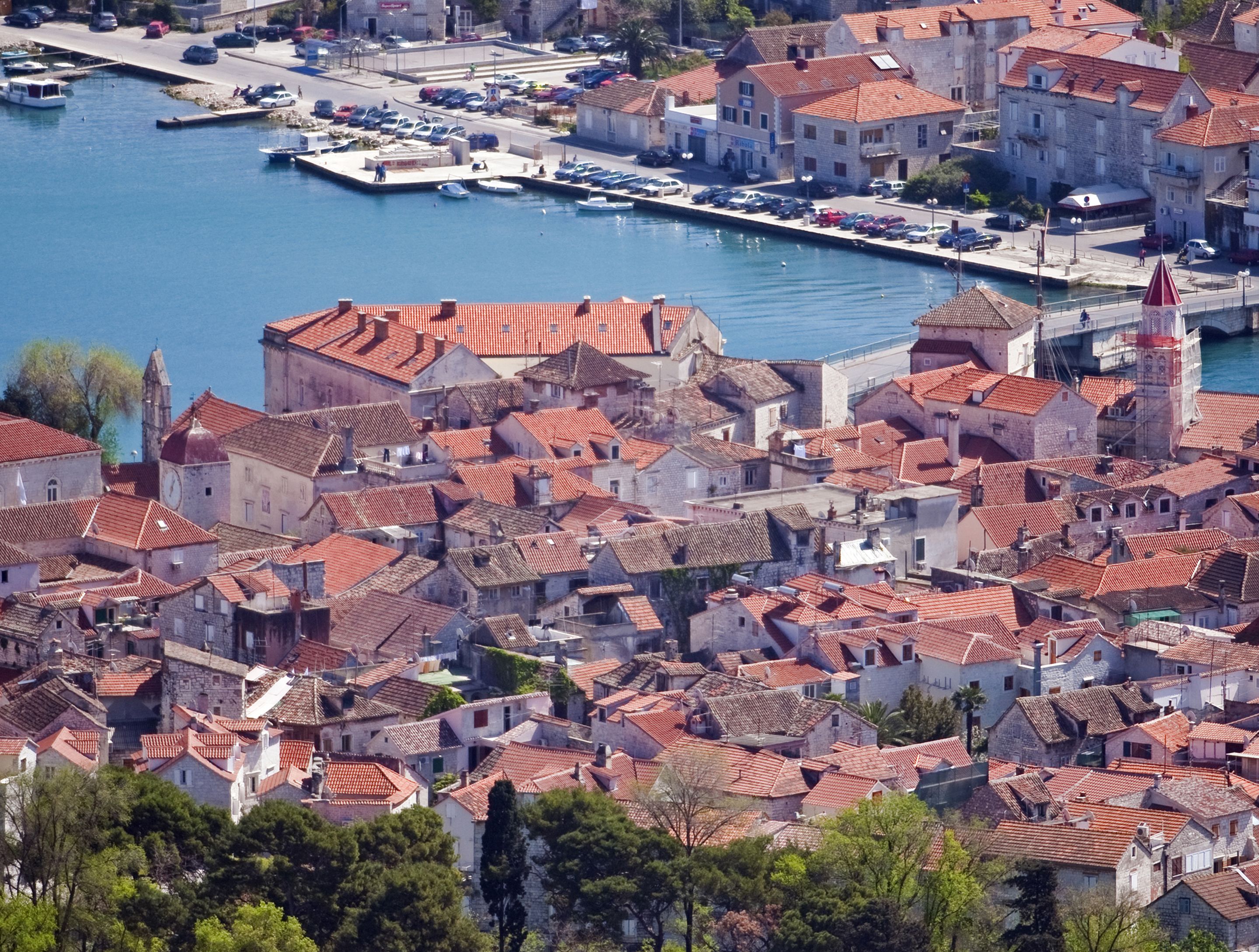 A coastal town with historic buildings, a marina, and a prominent church.