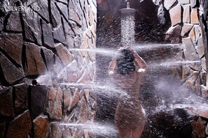 A person in a stone-walled area with a water feature. - Silverland Sil Hotel (Ho Chi Minh City)
