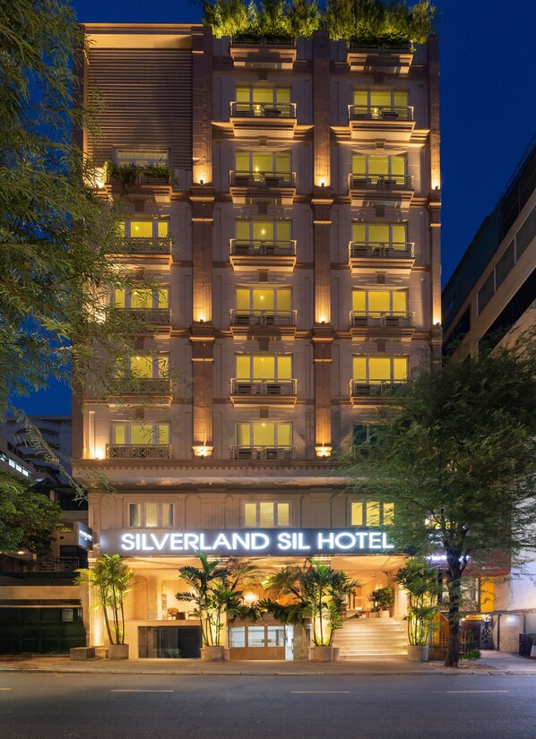 A multi-story hotel with balconies, a well-lit entrance, and a sign reading "Silverland SIL Hotel". - Silverland Sil Hotel (Ho Chi Minh City)