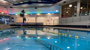 An indoor swimming pool with clear lane markings, a safety railing, and a pool depth sign. - Brook Mollington Banastre Hotel and Spa (Chester)