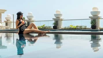 2 outdoor pools, open 7:00 AM to 7:00 PM, pool umbrellas, pool loungers