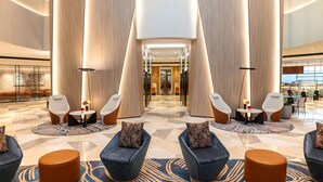 A spacious lobby with modern seating, a central light fixture, and a checkered floor pattern. - Sheraton Mall of the Emirates Hotel, Dubai (Dubai)