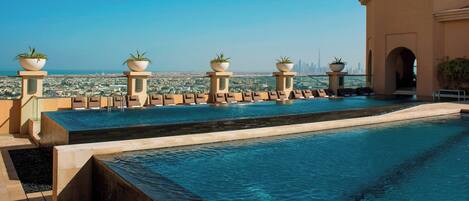 2 outdoor pools, open 7:00 AM to 7:00 PM, pool umbrellas, pool loungers