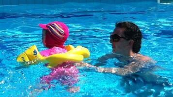 Guests can enjoy a refreshing swim in the pool, surrounded by a decorative border.