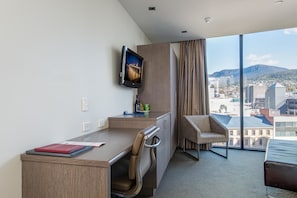 Enjoy a city view from the large window, relax on the sofa, and work at the desk with a flat-screen TV nearby.