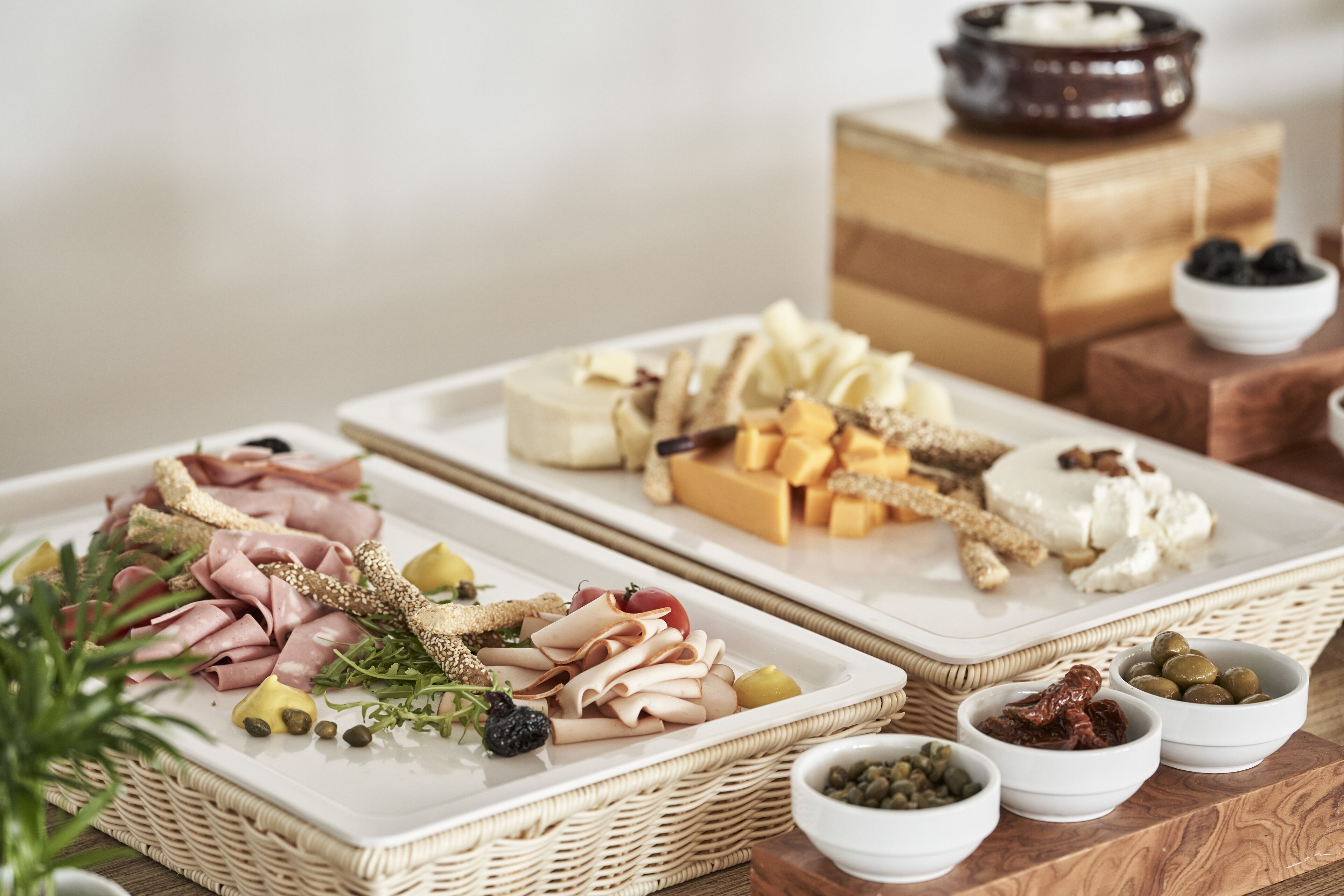 A charcuterie board with various meats, cheeses, and accompaniments.