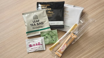 A variety of tea bags and a leaf tea bag on a wooden surface.