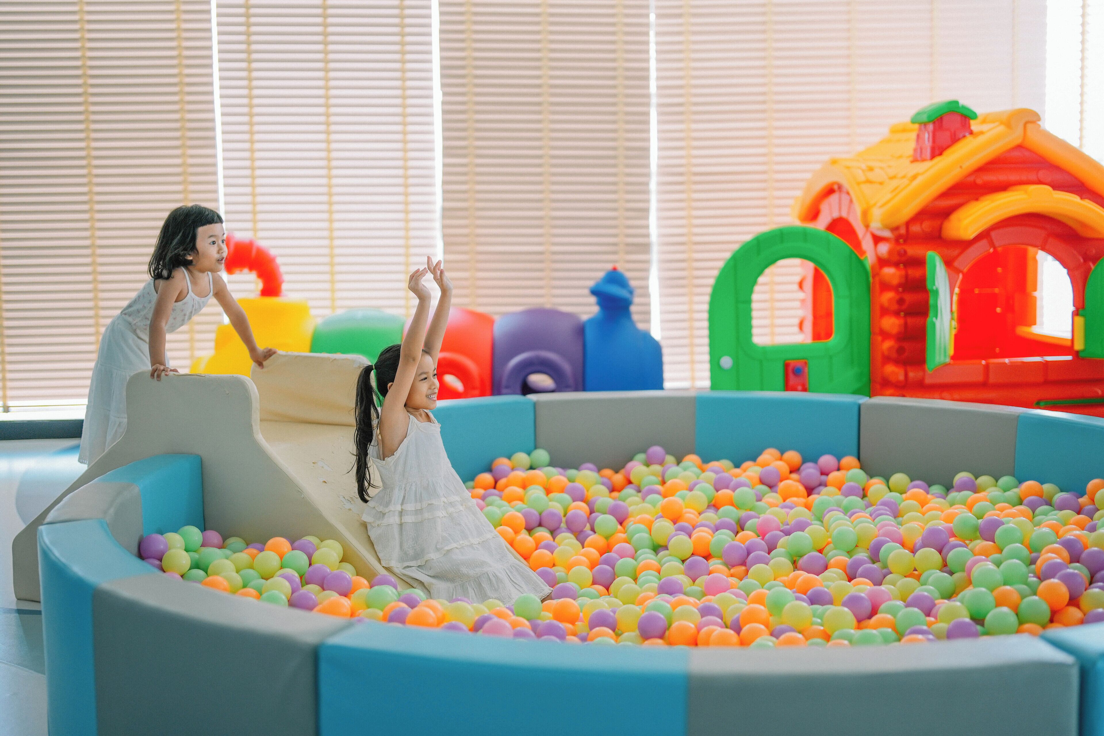 A play area with a ball pit and colorful play structures.