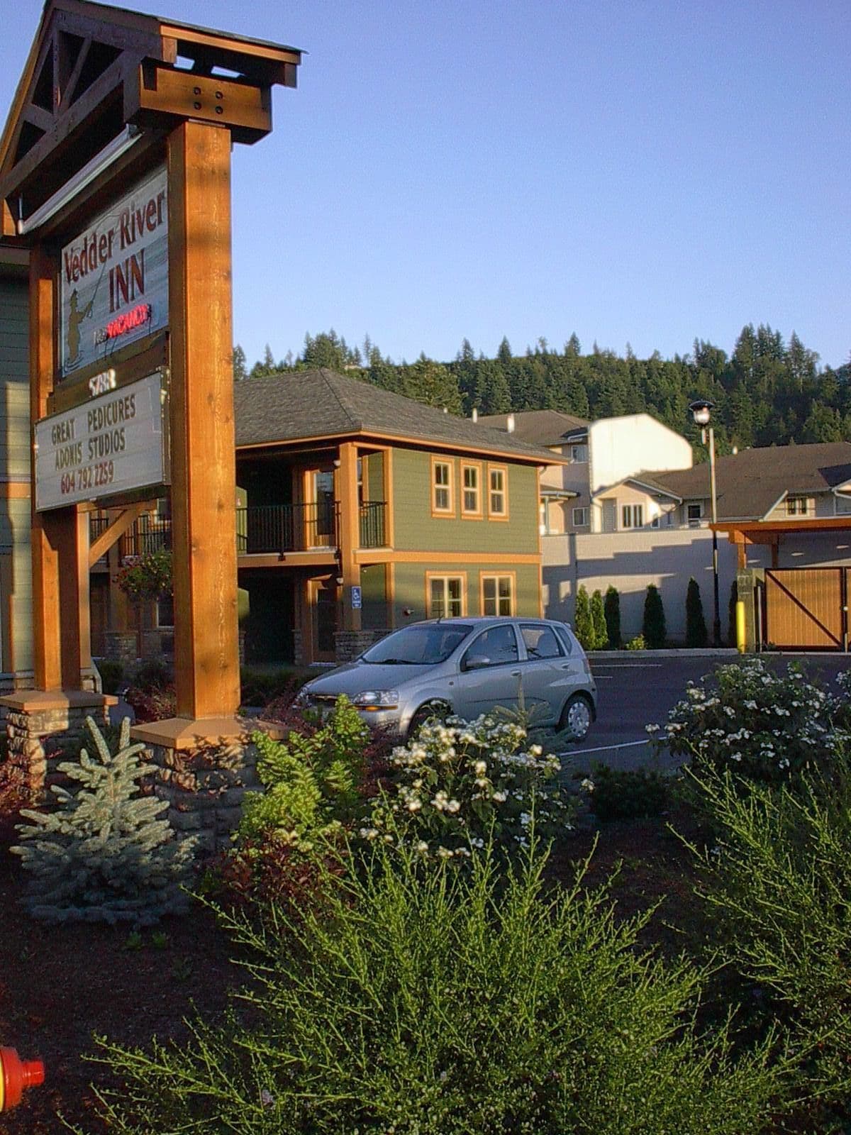 A building with a sign for Jedder River Inn and Great Pedicures.