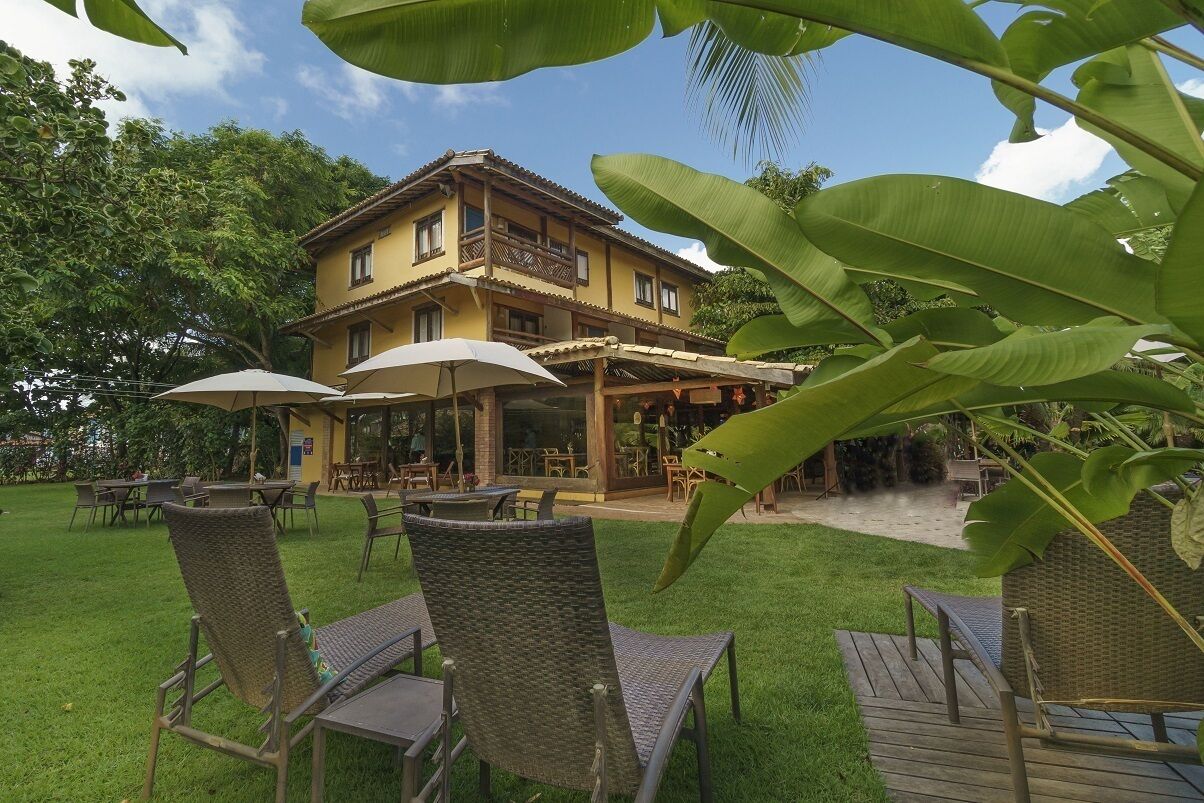 A building with outdoor seating and a covered patio area.