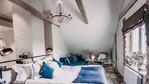 A bedroom with a large bed, a chandelier, a radiator, and a view of the outdoors. - Görvälns Slott (Jarfalla)