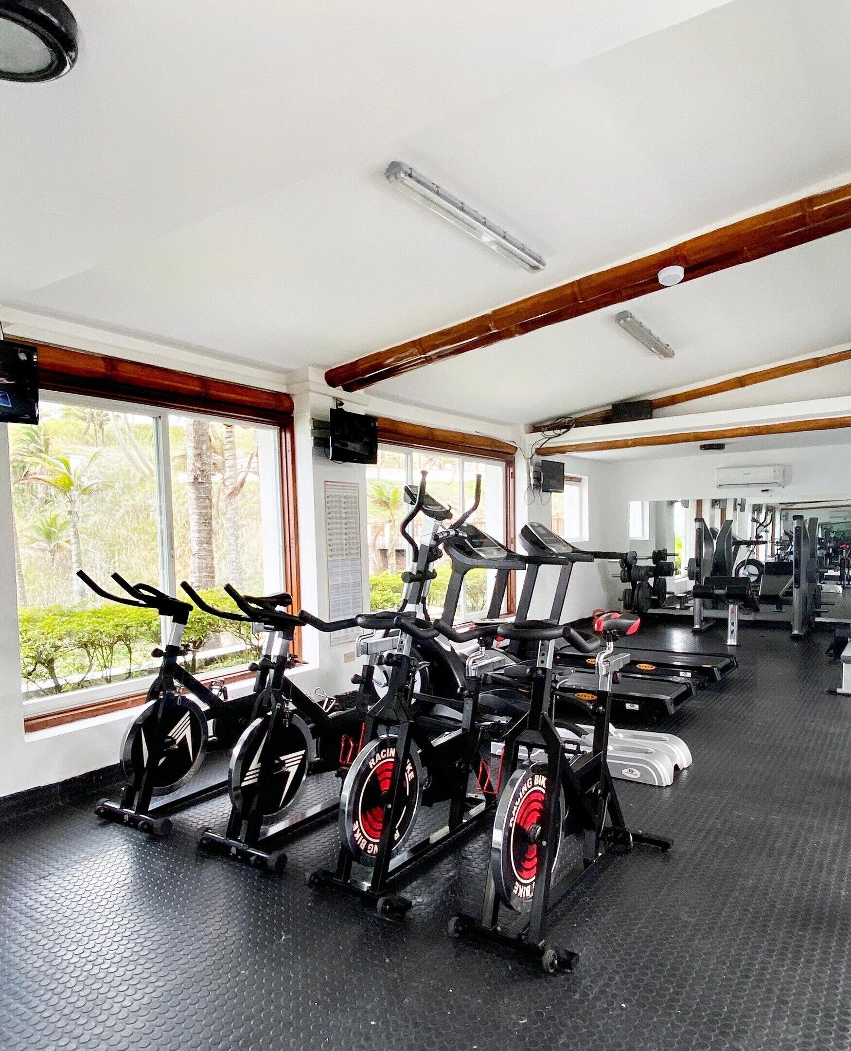 A gym with stationary bikes, treadmills, and weight machines.