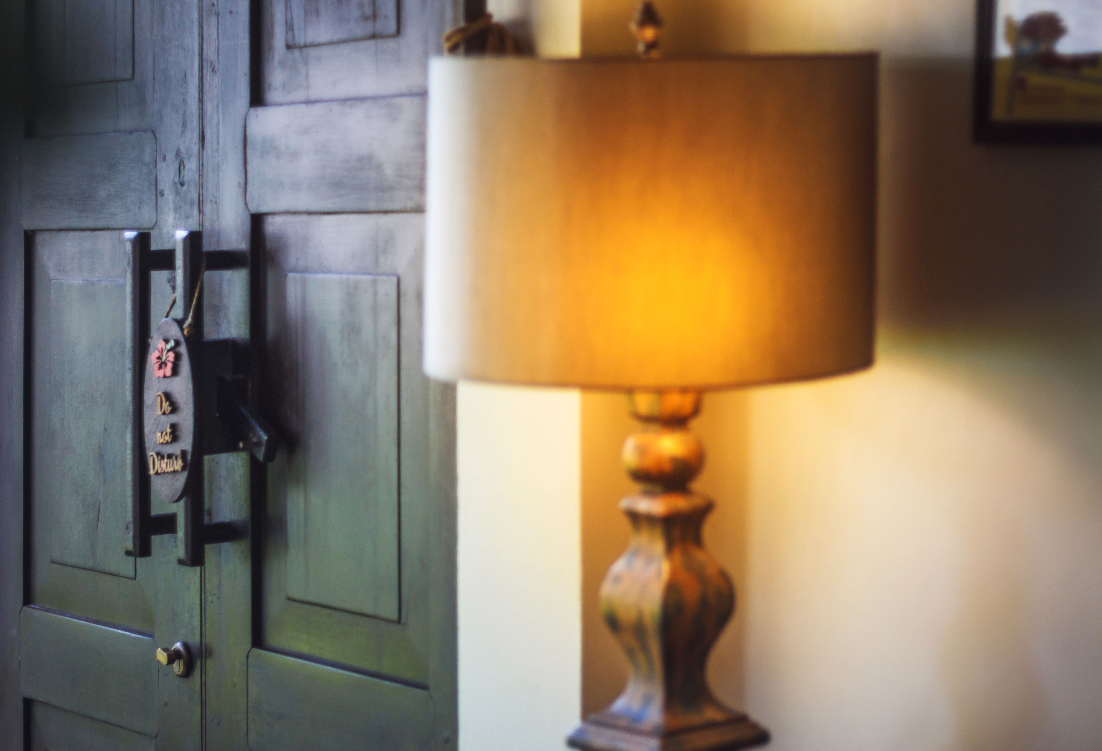 A door with a doorknob and a keyhole, and a lamp with a shade.