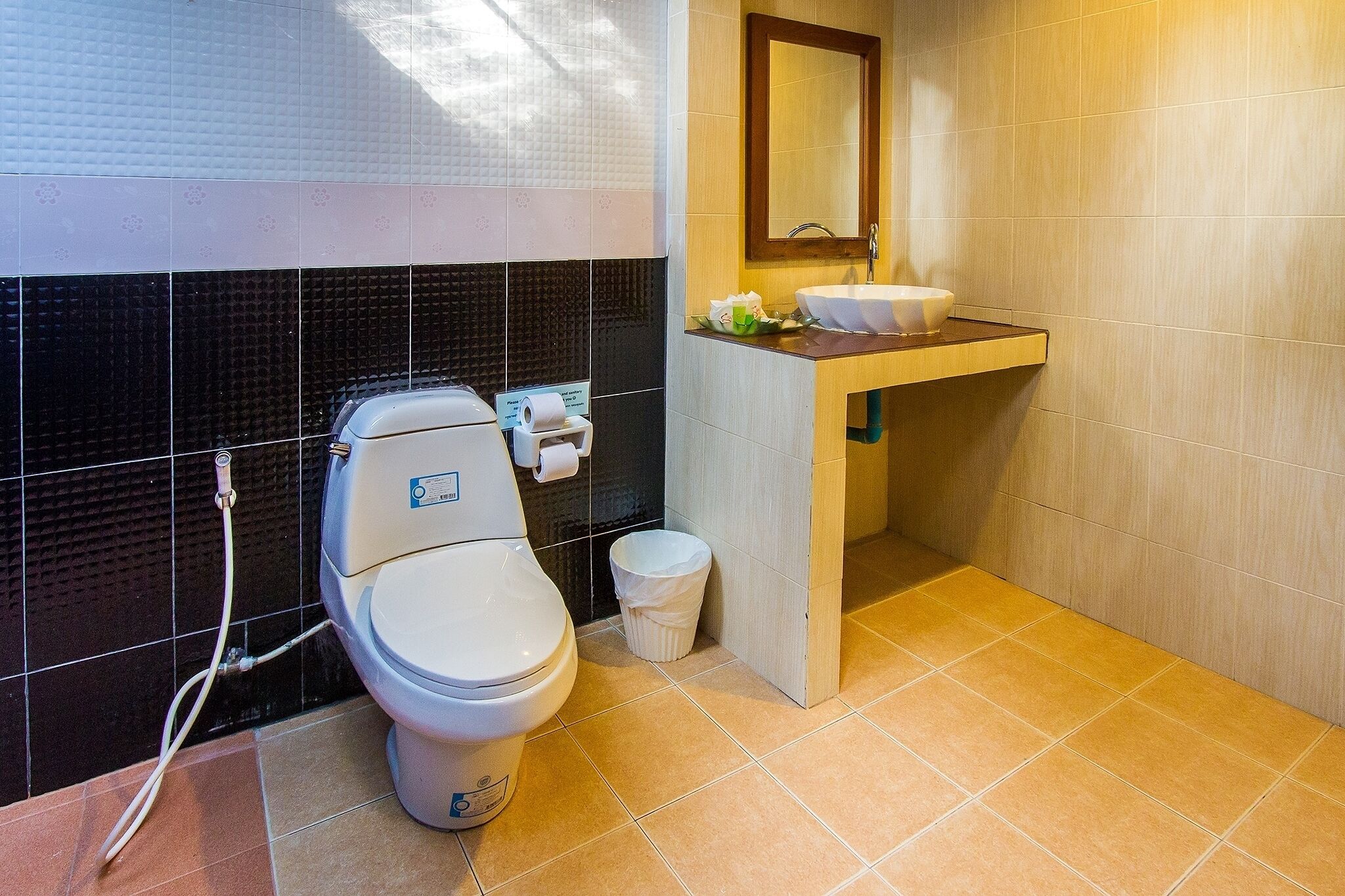 A modern bathroom with a toilet, sink, and mirror.