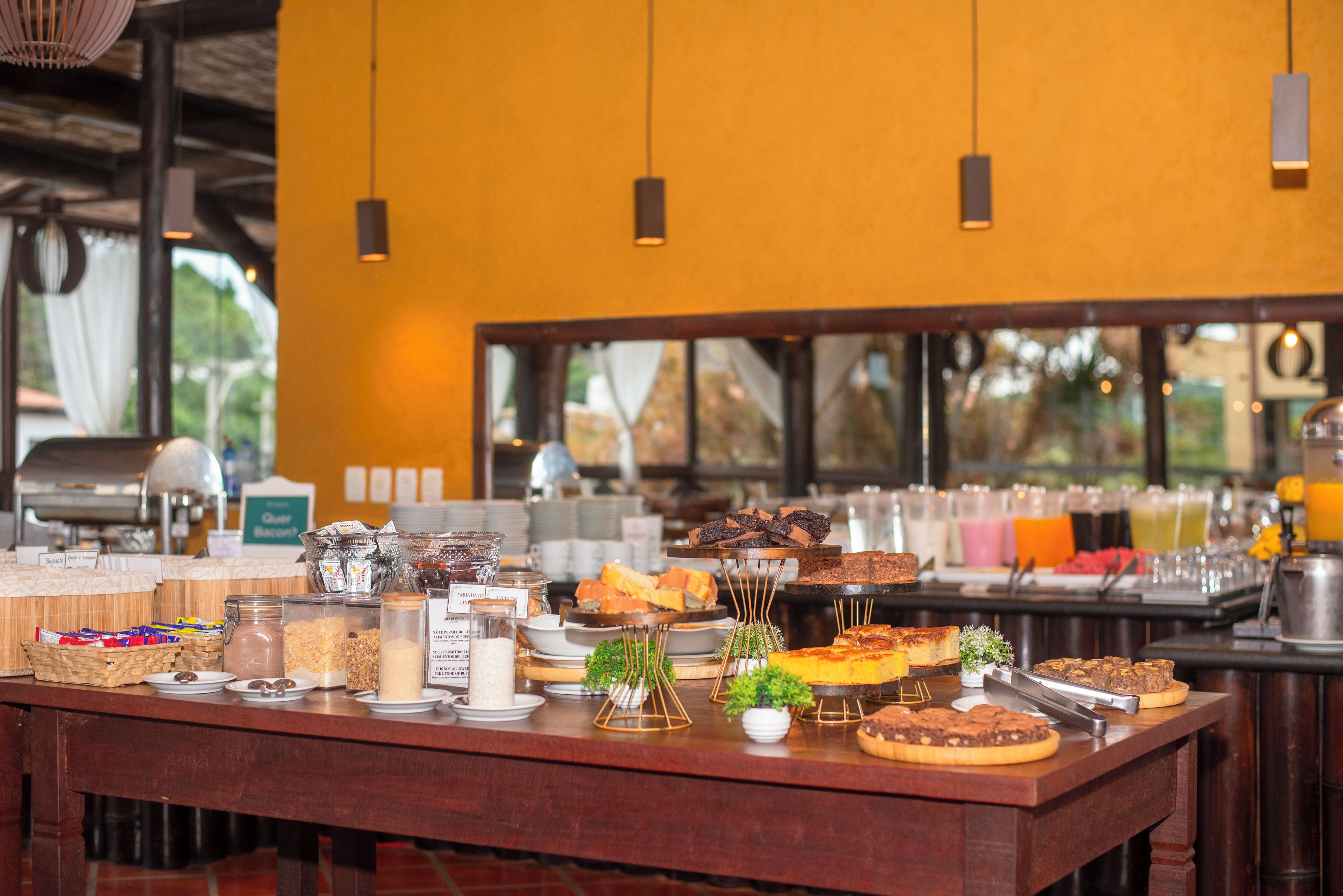 A buffet table with various food items and condiments.