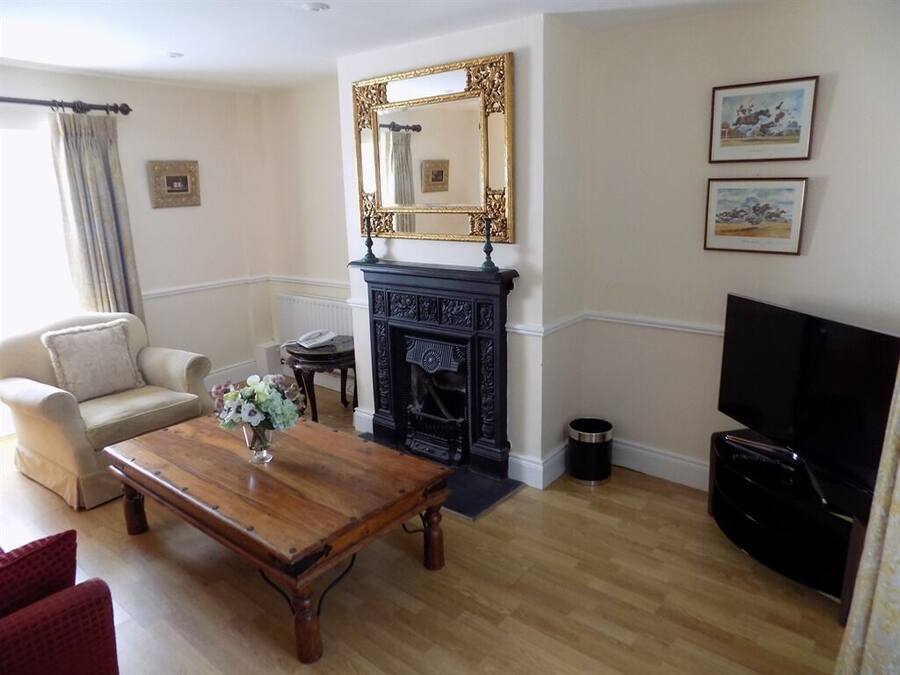 A living room with a fireplace, a television, and a sofa.