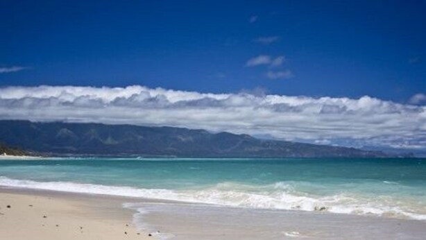 A beach with clear skies and distant mountains. - Bamboo Valley Inn (Haiku)