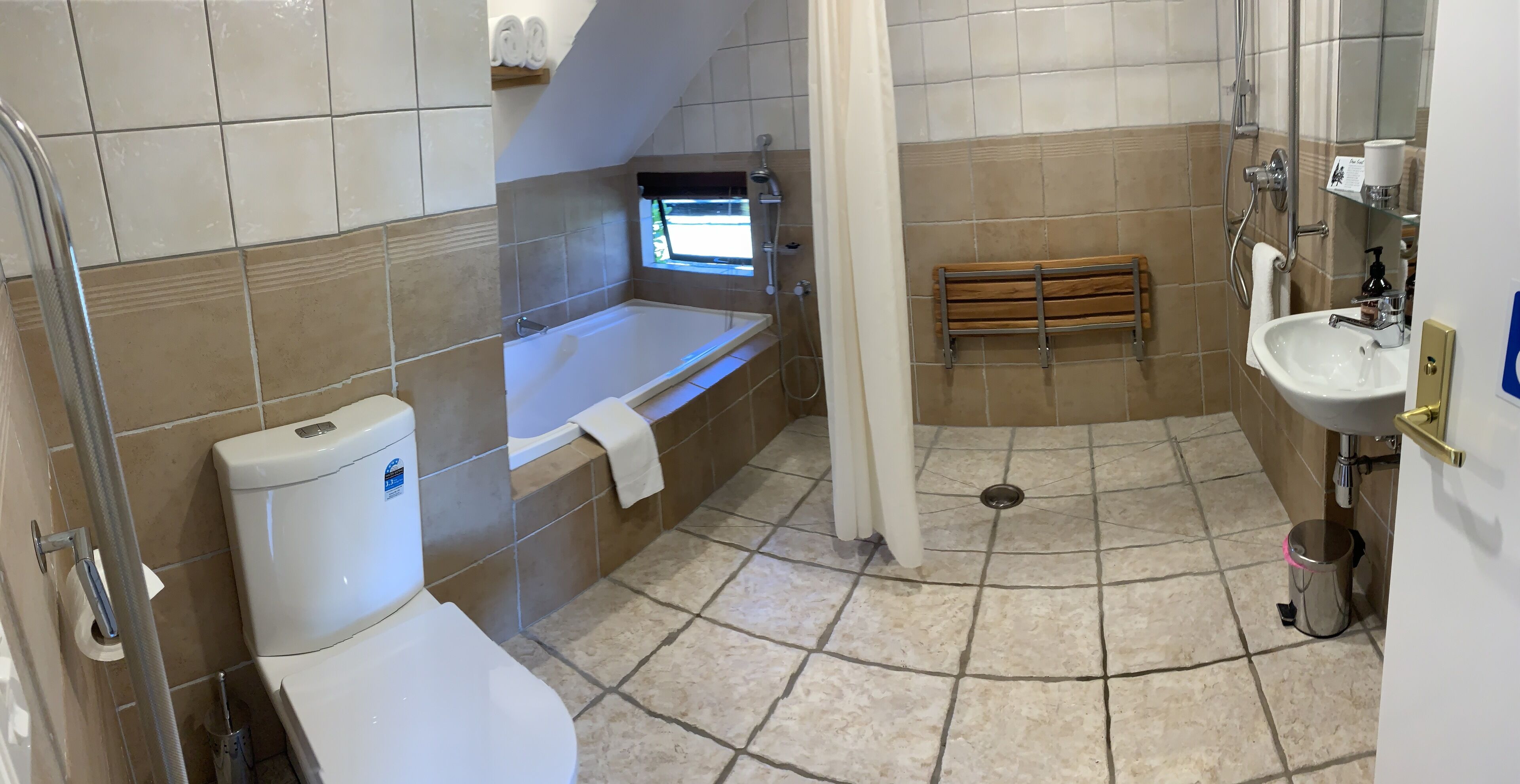 A bathroom with a bathtub, toilet, sink, and shower.