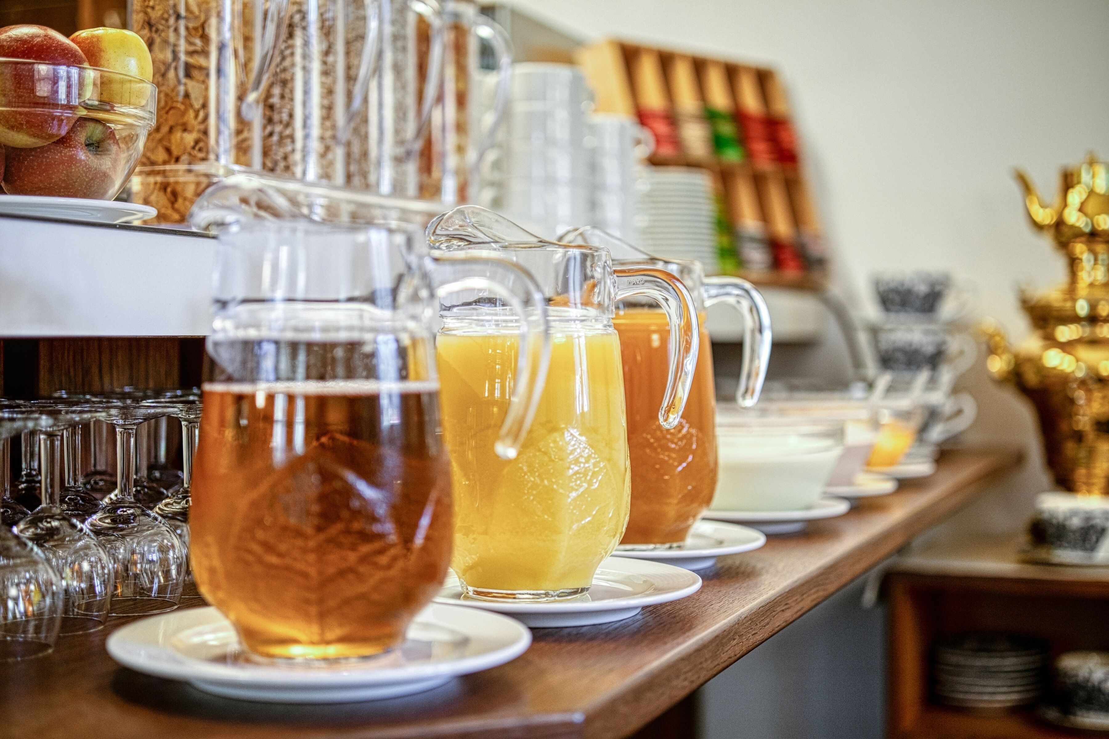 Un bufé de desayuno con diversas bebidas y frutas.