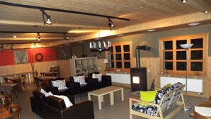 Una sala de estar acogedora con chimenea, sofás y un comedor.