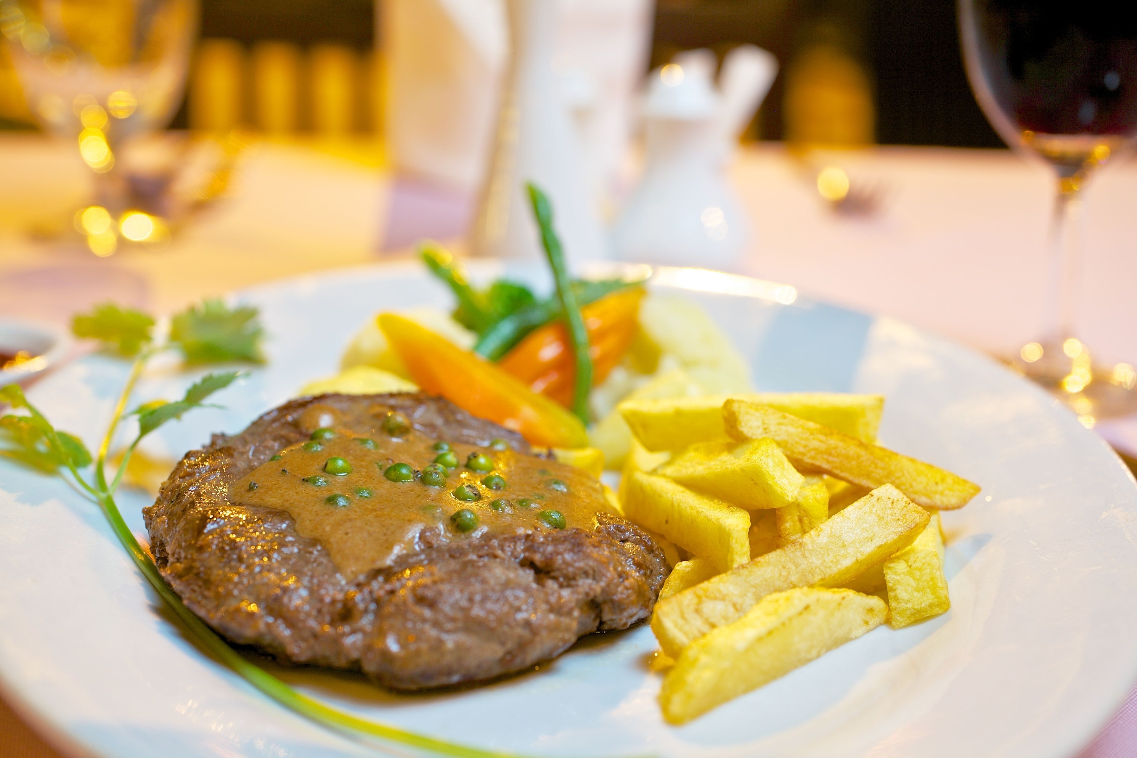 A plate with a steak, fries, and vegetables.