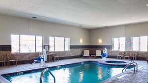 A hotel pool area with a 3ft deep end, lounge chairs, and a lifeguard chair. - Comfort Inn & Suites Monahans I-20 (Monahans)
