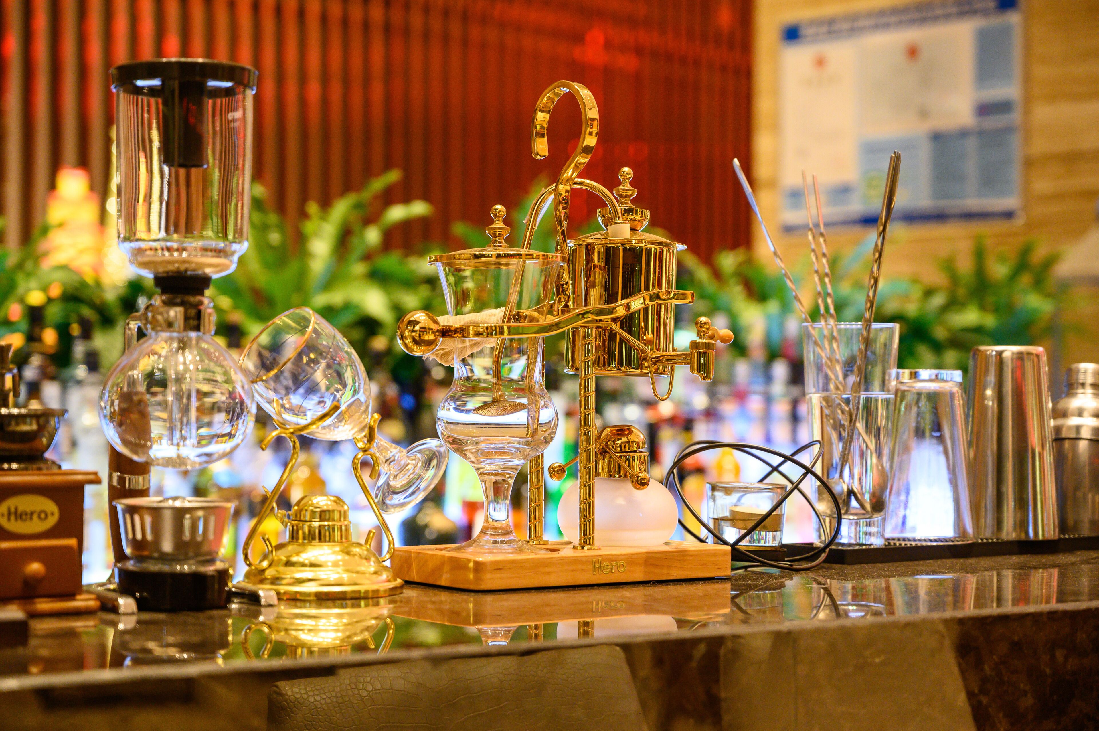 A bar area with various glassware and a coffee machine.