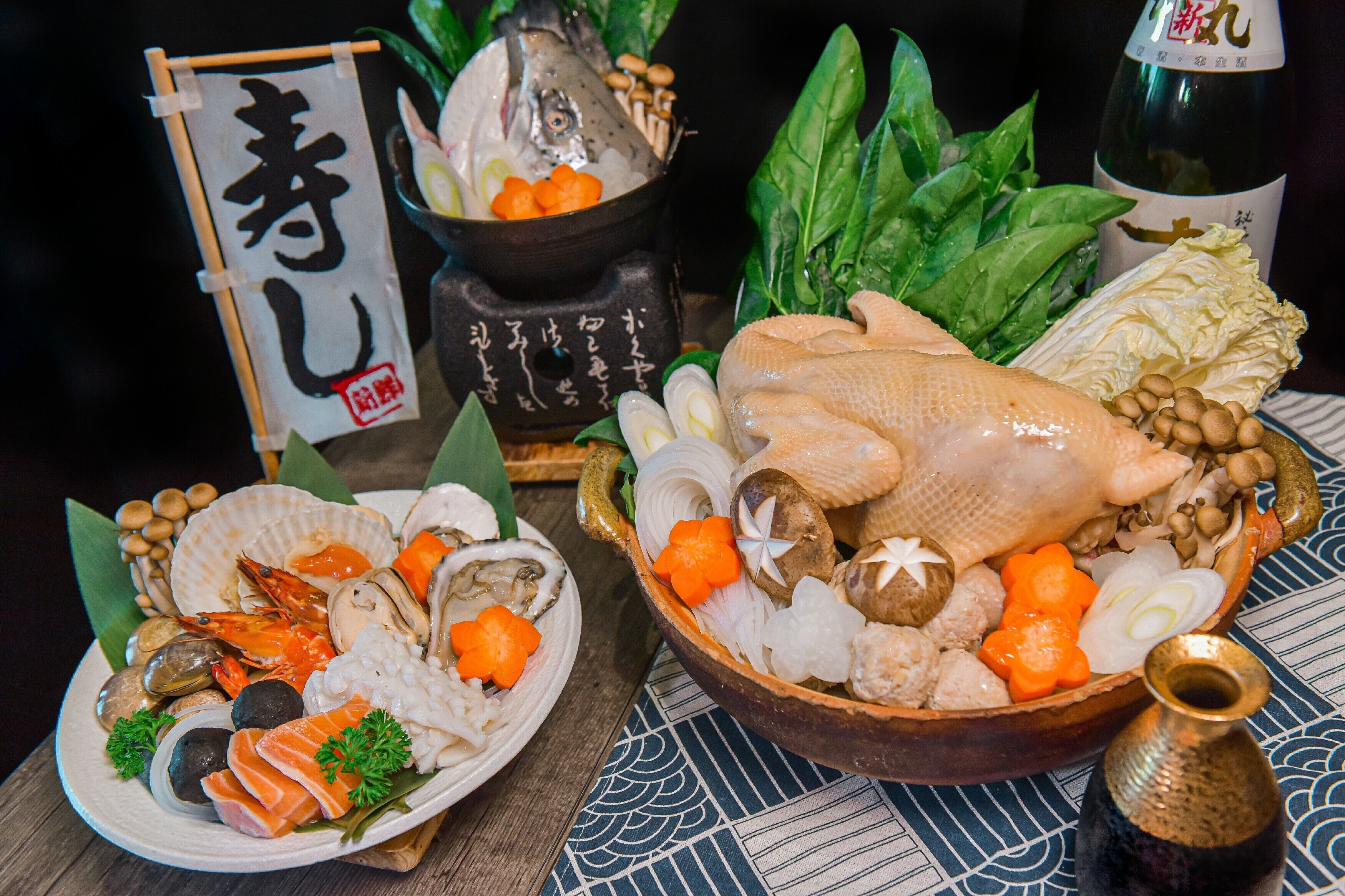 A variety of seafood and vegetables on a table, including a whole fish, shrimp, and mushrooms.