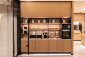 A modern kitchen with built-in appliances and storage cabinets. - Ji Hotel (Suzhou)