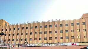 A multi-story hotel with a uniform facade, featuring a series of windows and balconies. -  Grand Astoria Hotel (Dubai)
