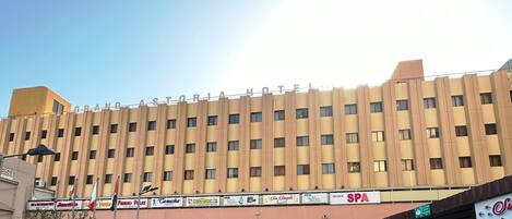 A multi-story hotel with a uniform facade, featuring a series of windows and balconies.