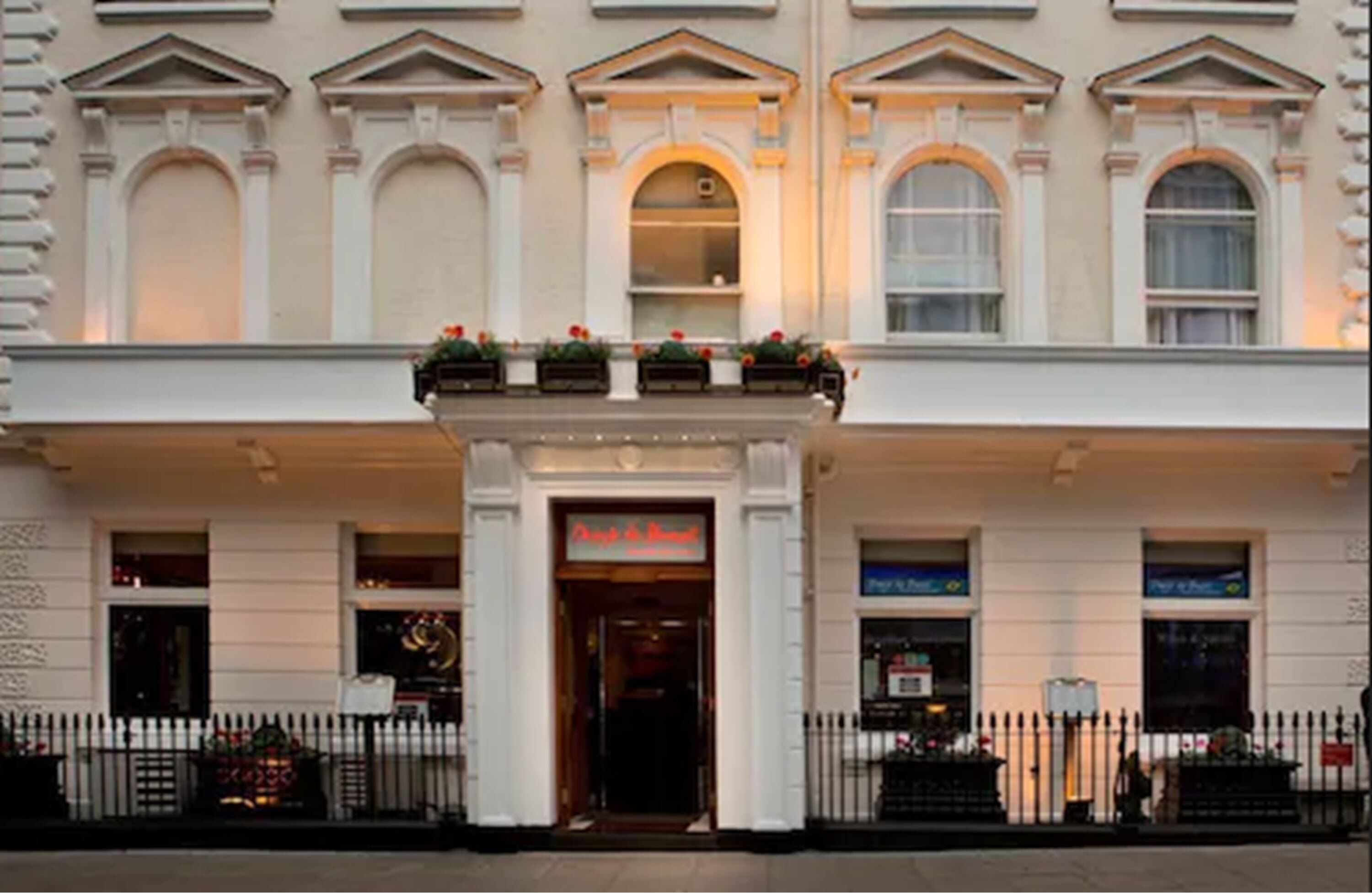 A classical building facade with arched windows and a central entrance.