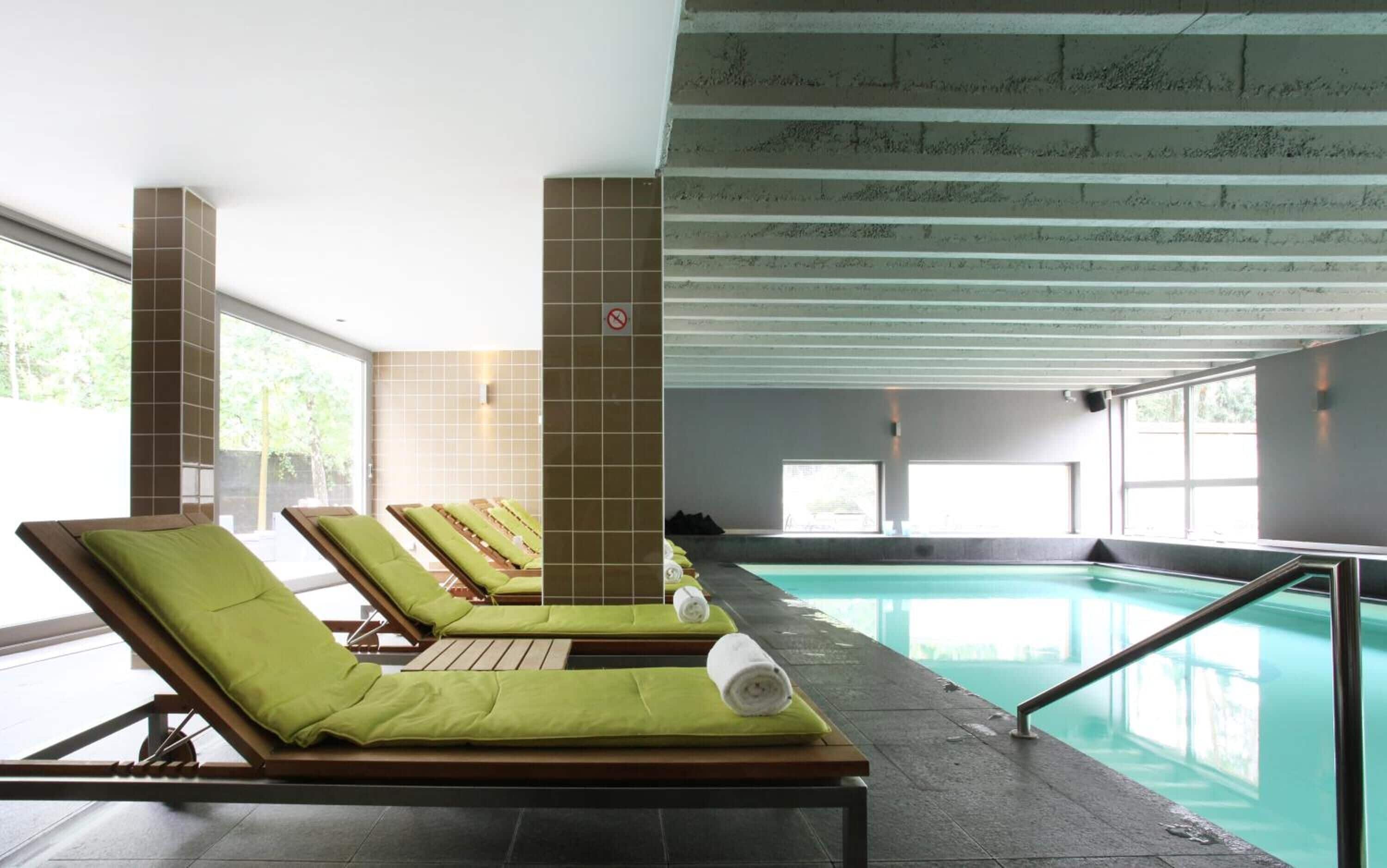 A poolside area with sun loungers and a pool.