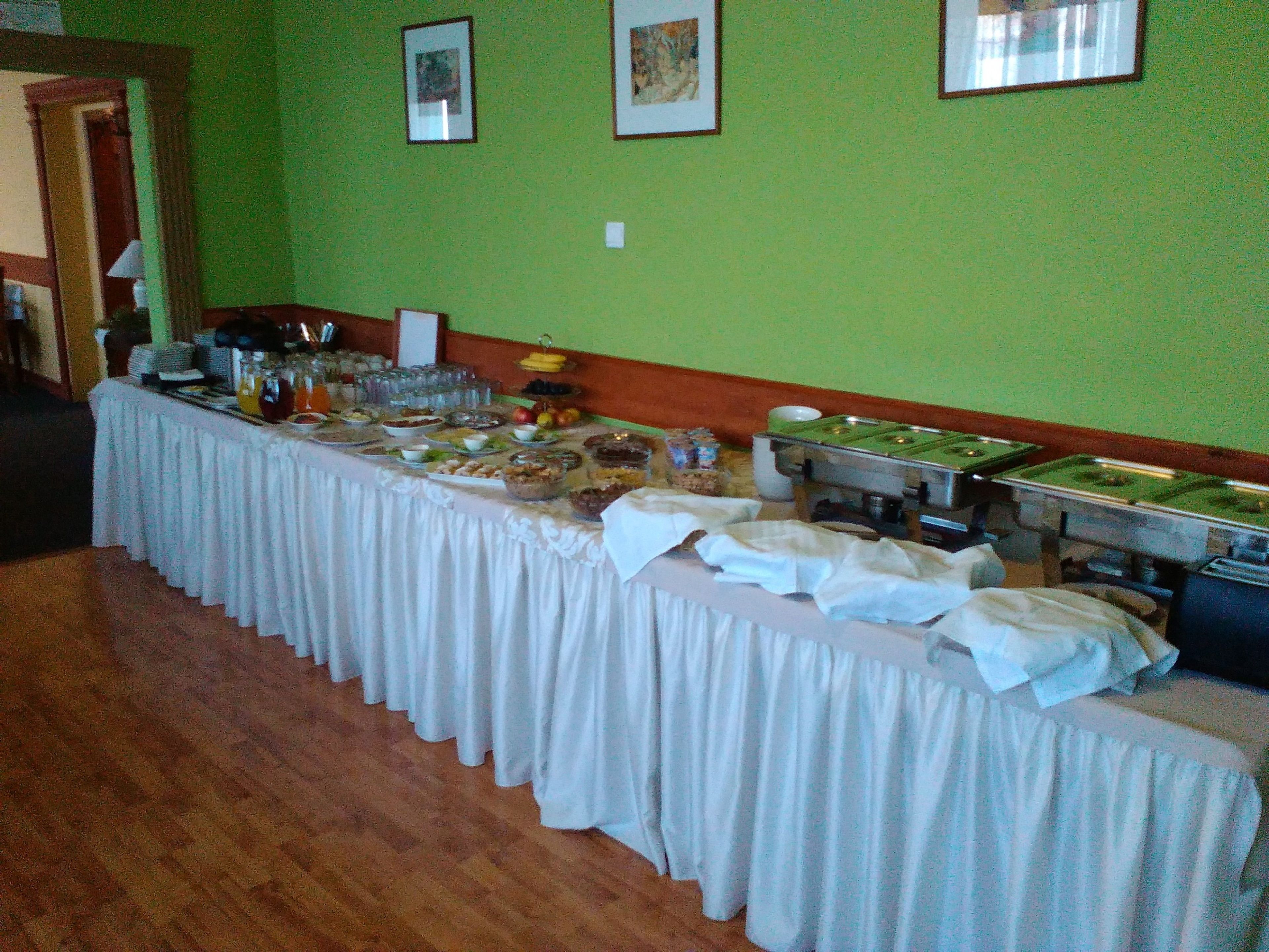 A buffet setup with various food items and a stove on the right side.