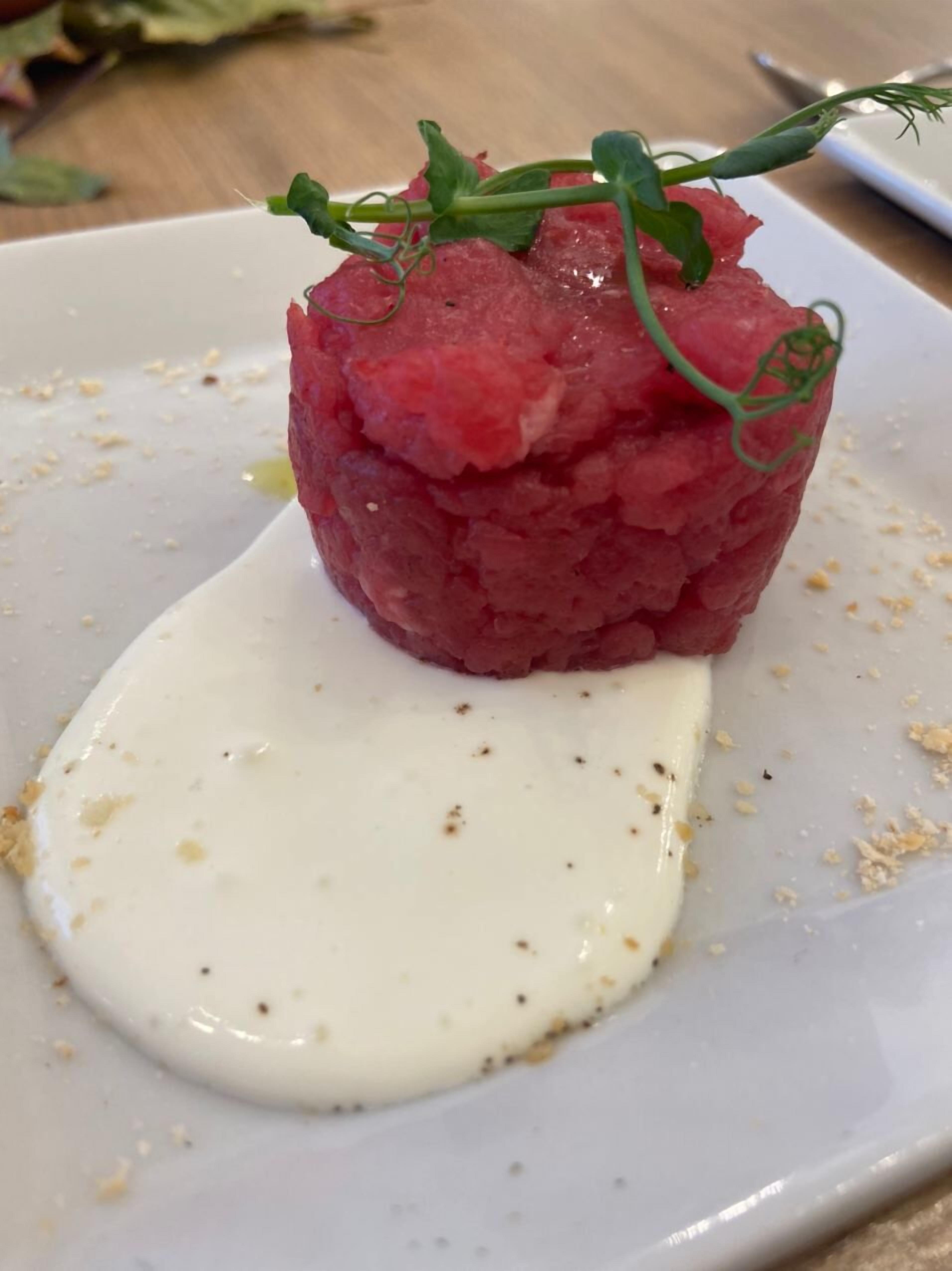 A plated dish with a creamy sauce and a garnish.