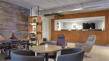 Relax and work in style with a sofa, armchairs, and a round table in this lounge area.