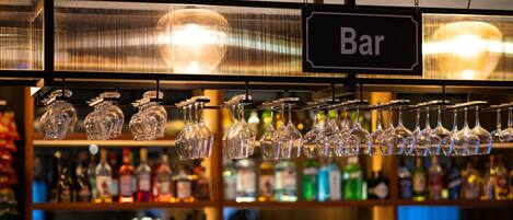 A bar area with hanging wine glasses and a 'Bar' sign.