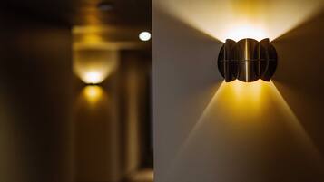 A wall-mounted light fixture with a cylindrical design and a warm glow.