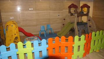 Kids can play and climb in this fun play area featuring a slide and a climbing structure.