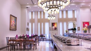 A spacious dining area with a long table, chairs, and a decorative chandelier. - Rayan Hotel Sharjah (Sharjah)