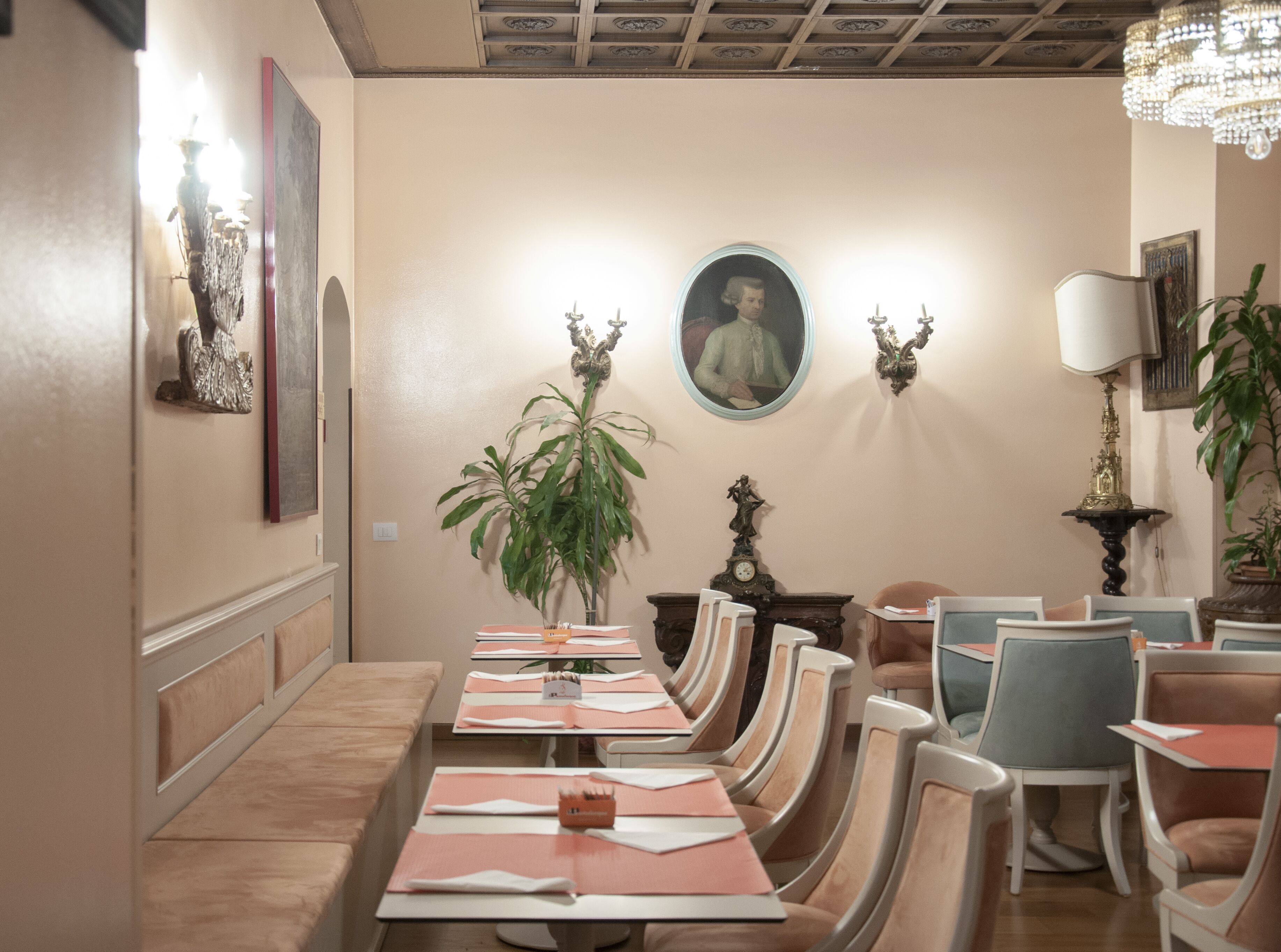 A dining area with a long table set for a meal, surrounded by chairs.