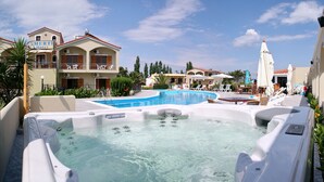 A hotel with a swimming pool, hot tubs, and outdoor seating areas. - Imerti Hotel (Lesvos)