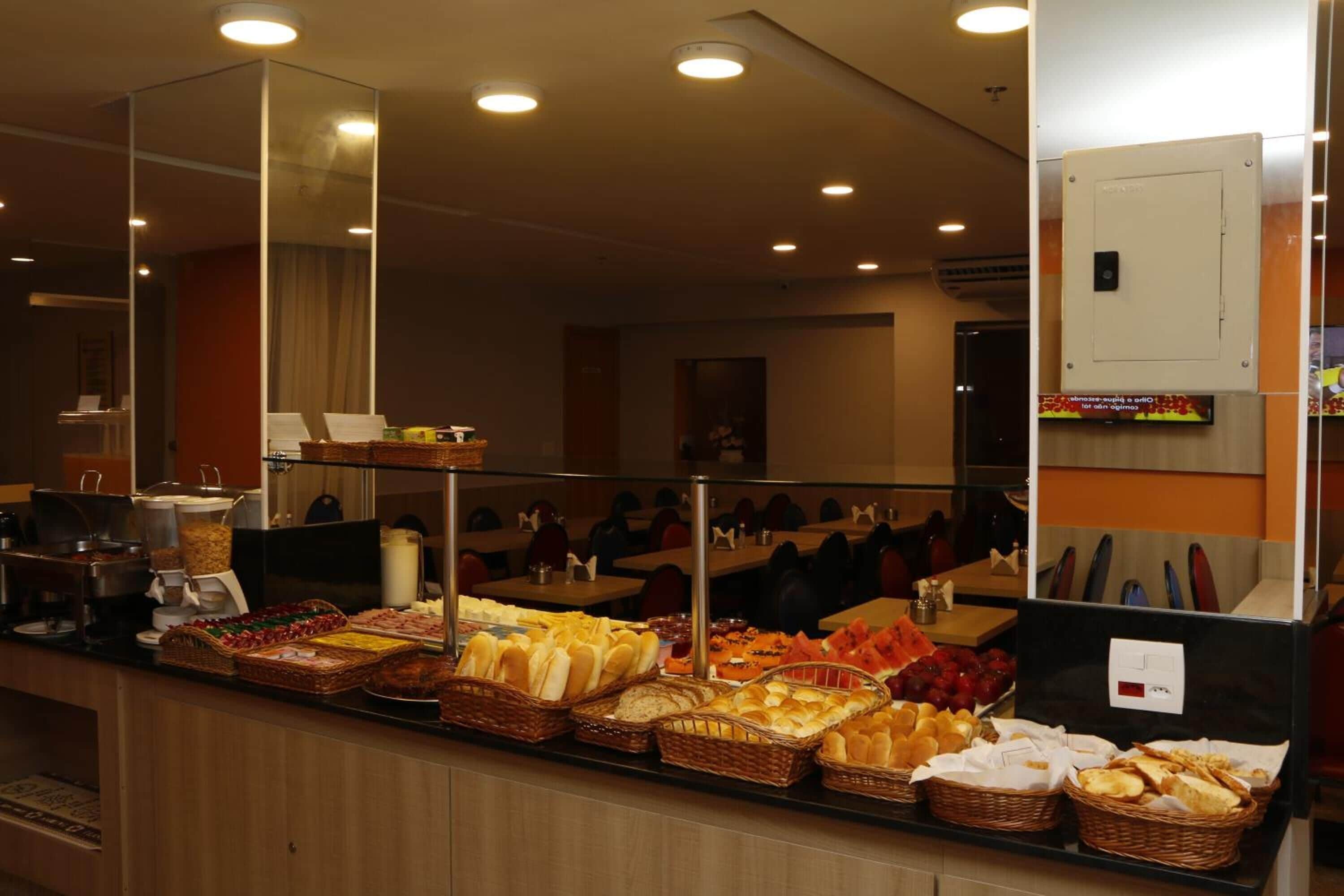 A buffet area with various food items and a mirror reflecting the room.