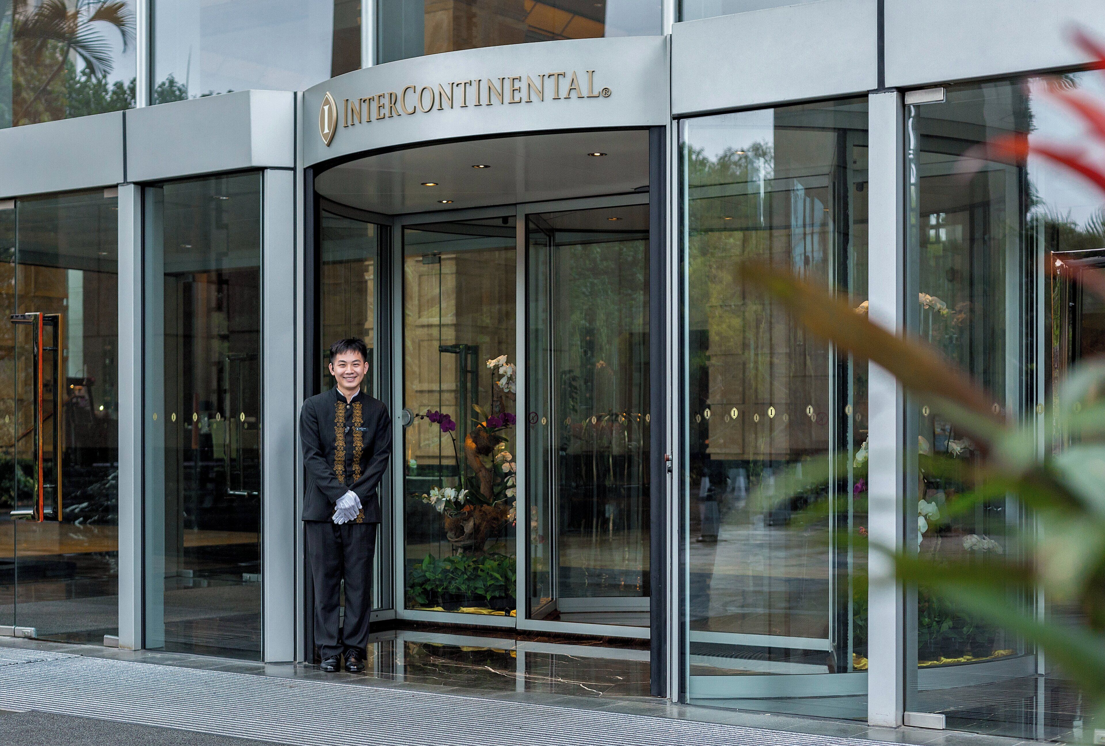 A modern building with a glass entrance and a sign reading 'INTERCONTINENTAL.'