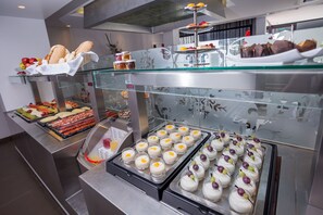 A buffet with various food items including pastries, fruits, and desserts. - Migjorn Ibiza Suites & Spa (Sant Josep de sa Talaia)