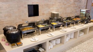 A buffet with various food stations, including a salad bar, a fruit section, and a meat station. - ibis Dongguan Dongcheng (Dongguan)